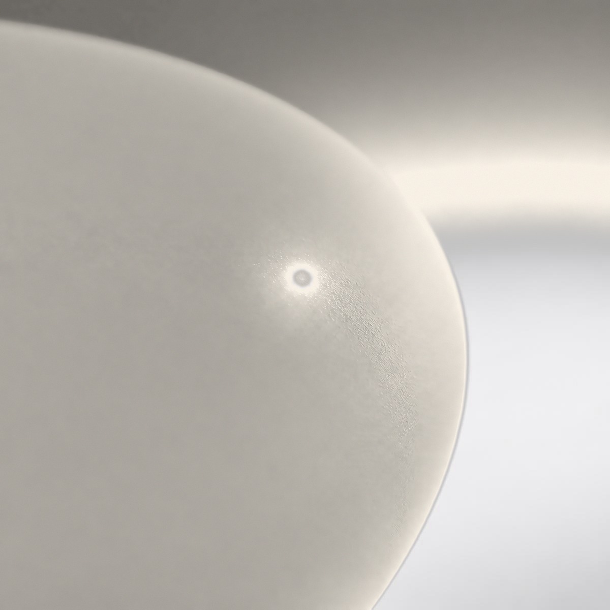 Macro view of the soft status LED glowing under the silicone